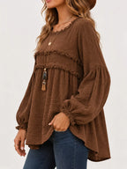 Brown peplum blouse front side view with frayed ruffle trim and gathered cuffs