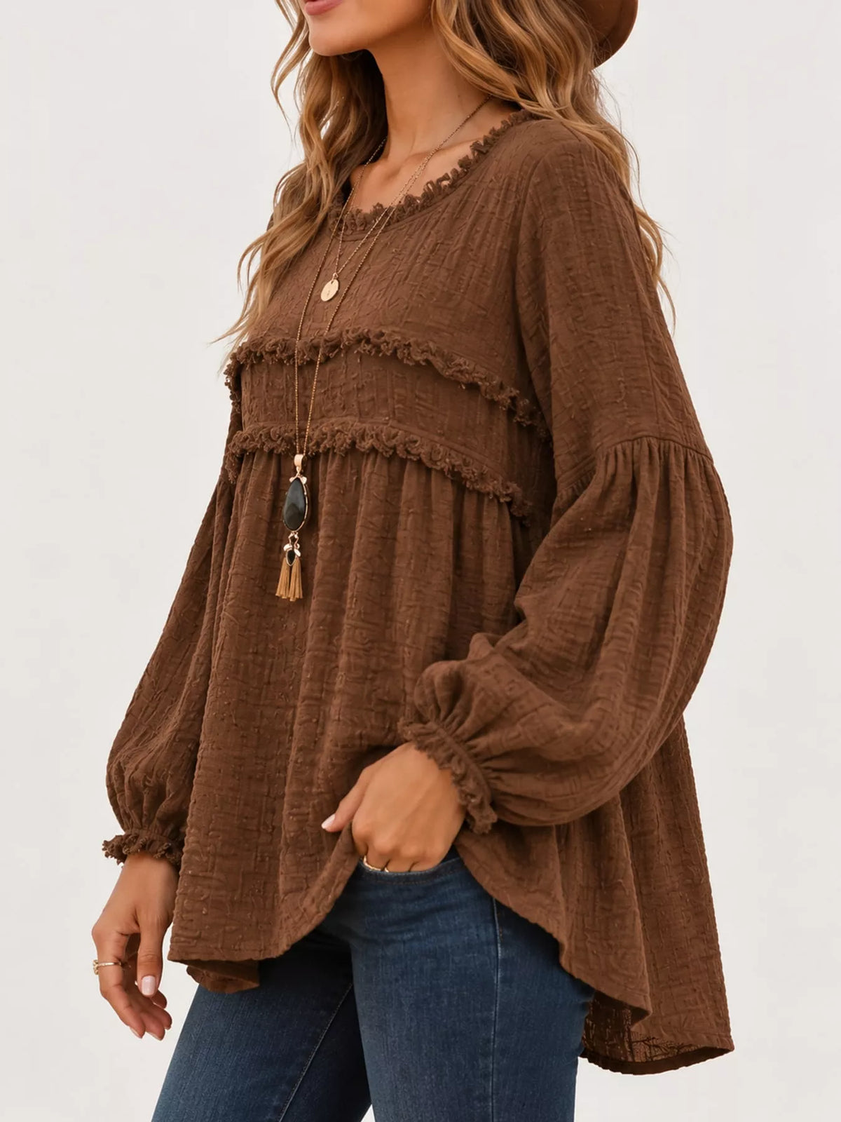Brown peplum blouse front side view with frayed ruffle trim and gathered cuffs