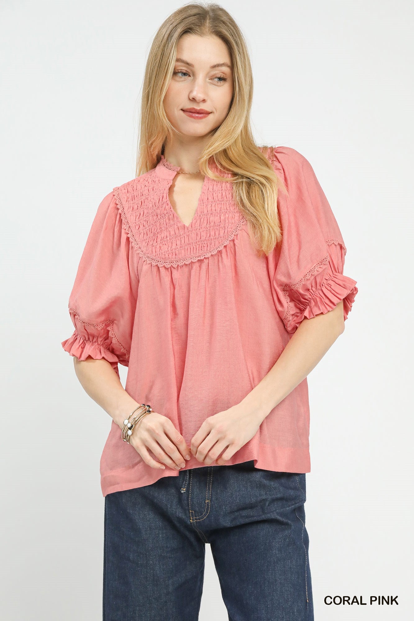 Coral pink smocked yoke ruffle-sleeve blouse with keyhole neckline