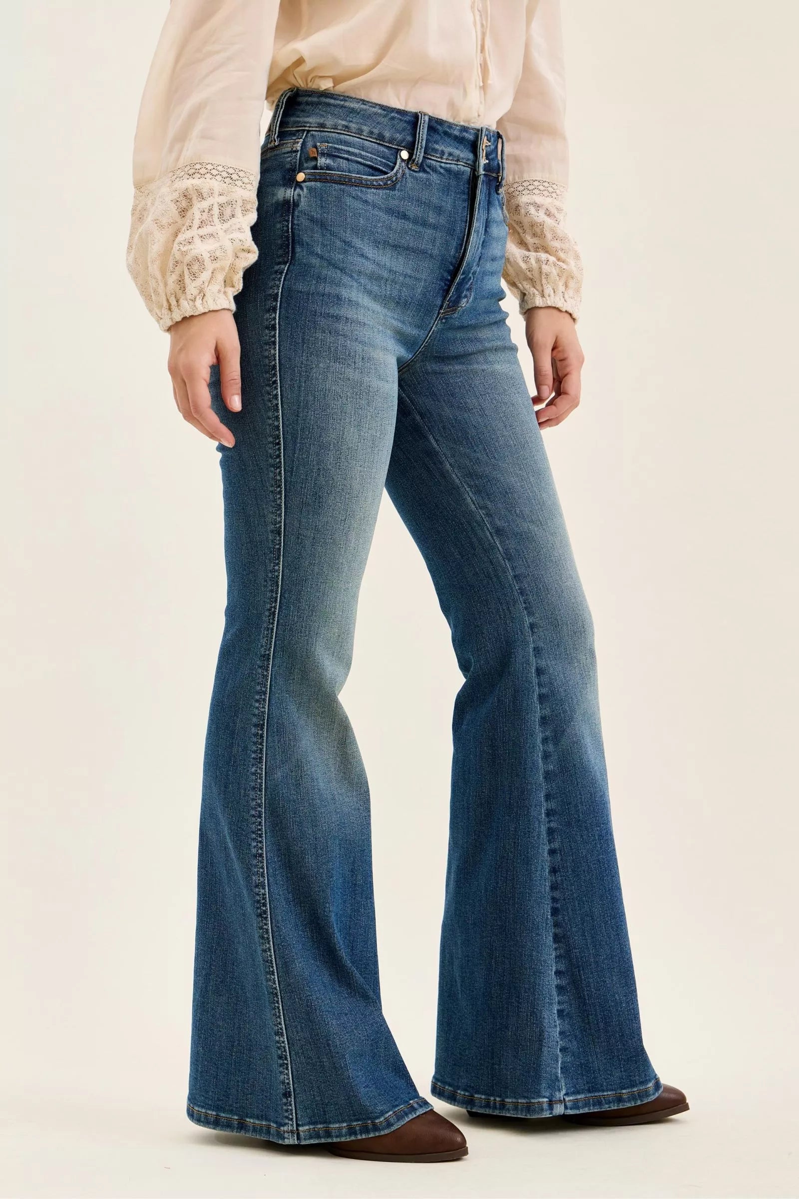 High-waist flare jeans, medium blue denim wash, wide bell-bottom leg opening, belt loops