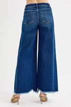 Women’s high-rise wide-leg jeans in blue wash denim, back patch pockets, frayed hems
