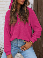 Waffle-knit button hoodie in fuchsia, hooded with drawstrings and long sleeves.