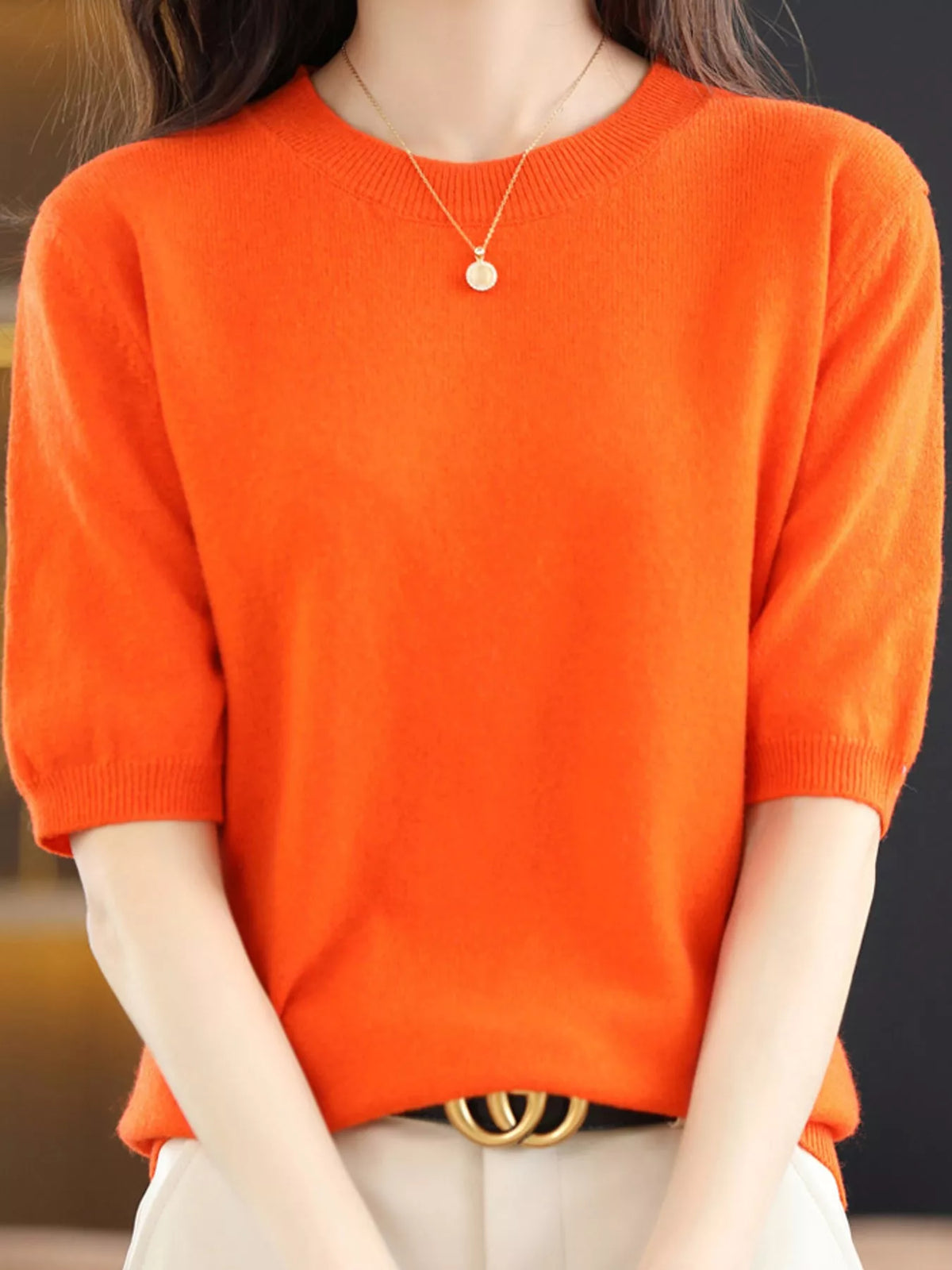 Bright orange round-neck short-sleeve knit sweater with ribbed neckline