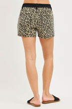 High-rise leopard-print shorts with black waistband and button front, relaxed fit