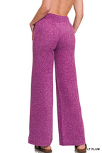 Back view of plum wide-leg pants with elastic waistband and drawstring, full length