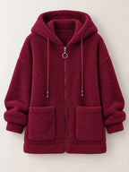 Burgundy fleece zip-up hoodie with drawstring hood and front patch pockets, zip front.
