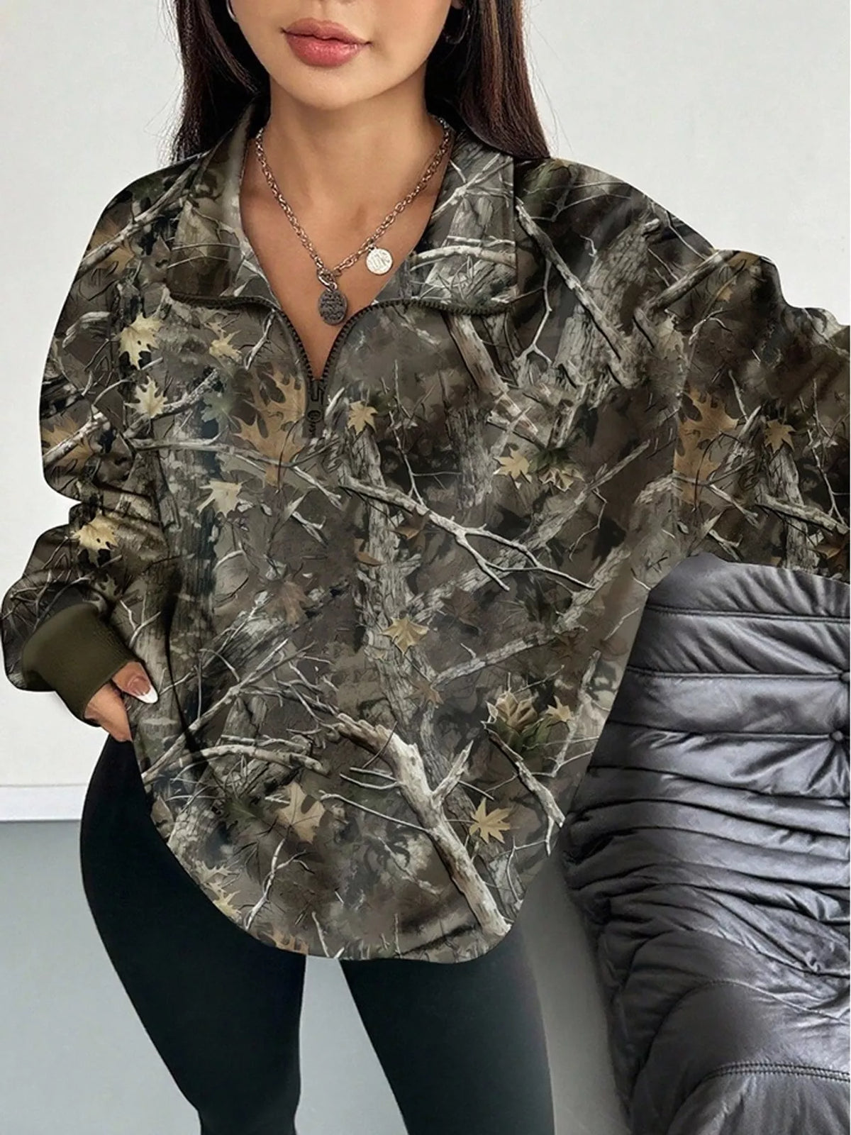 Dark army green camo zip-neck oversized sweatshirt with front half-zip and long sleeves