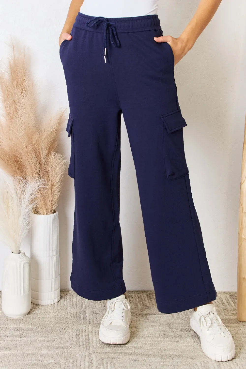 Dark blue drawstring wide-leg cargo pants with front flap pockets