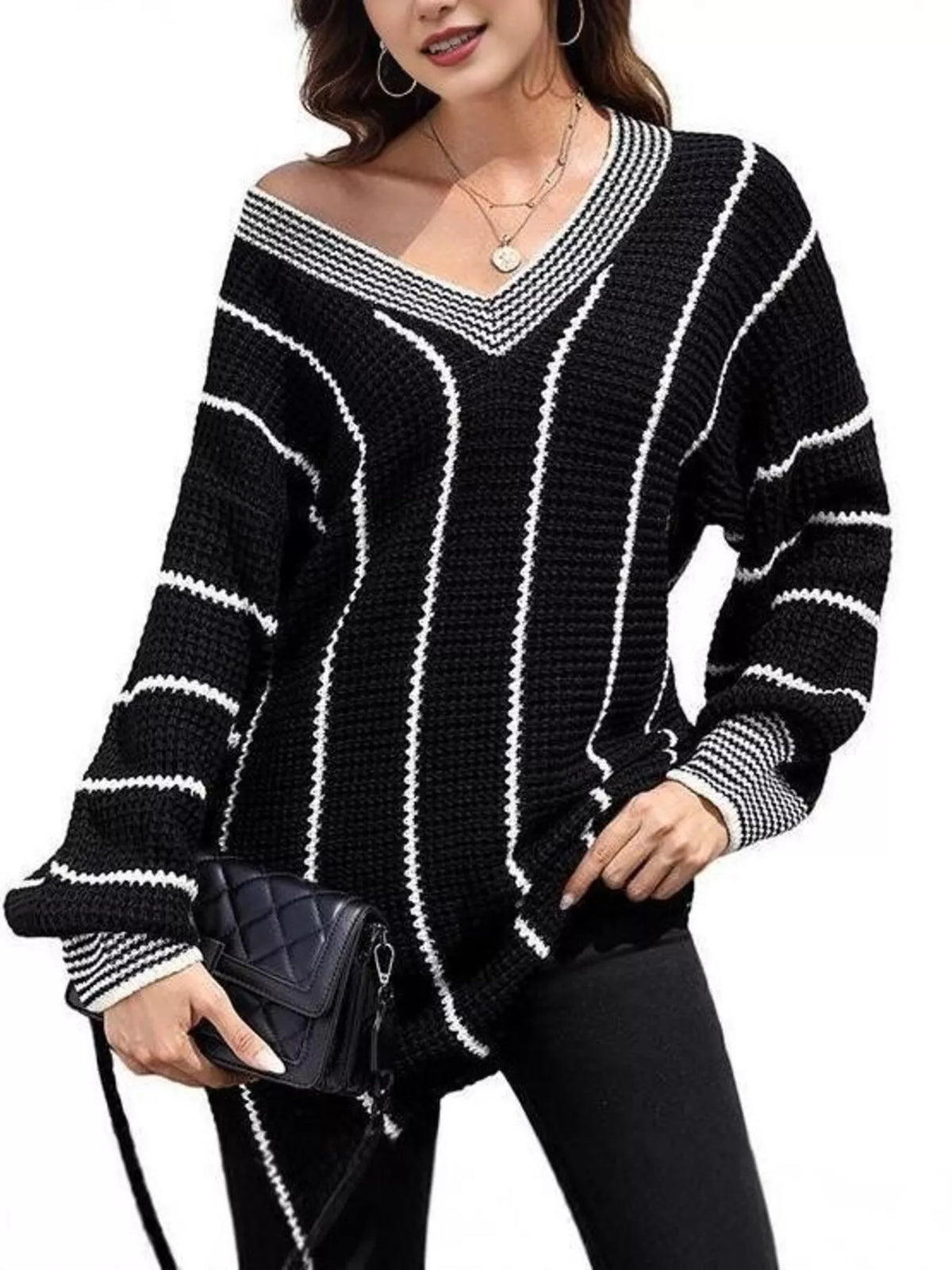 Black V-neck textured knit sweater with white vertical stripe pattern and ribbed cuffs