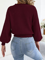 Back view of wine red argyle lantern-sleeve sweater with ribbed waistband and cuffs