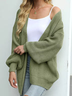 Chunky knit lantern sleeve cardigan in olive green, open front, ribbed textured knit.