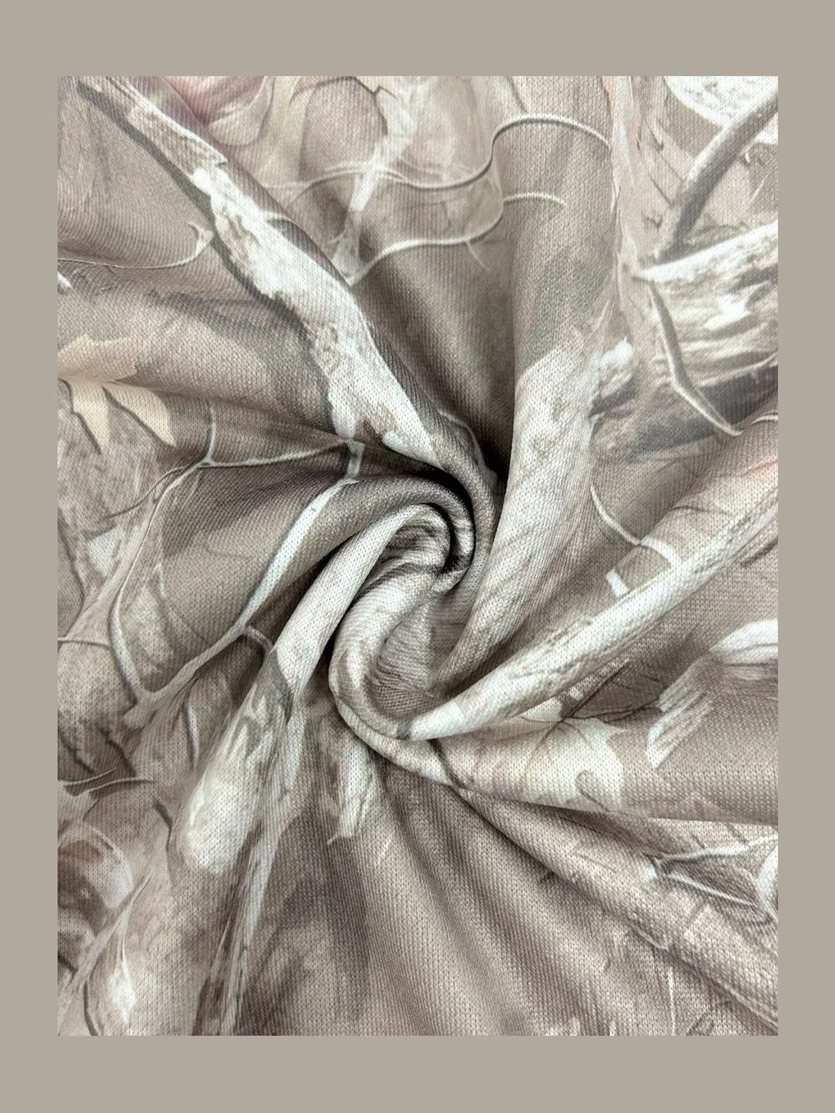 Light gray camo sweatshirt fabric close-up with swirling pattern and knit texture