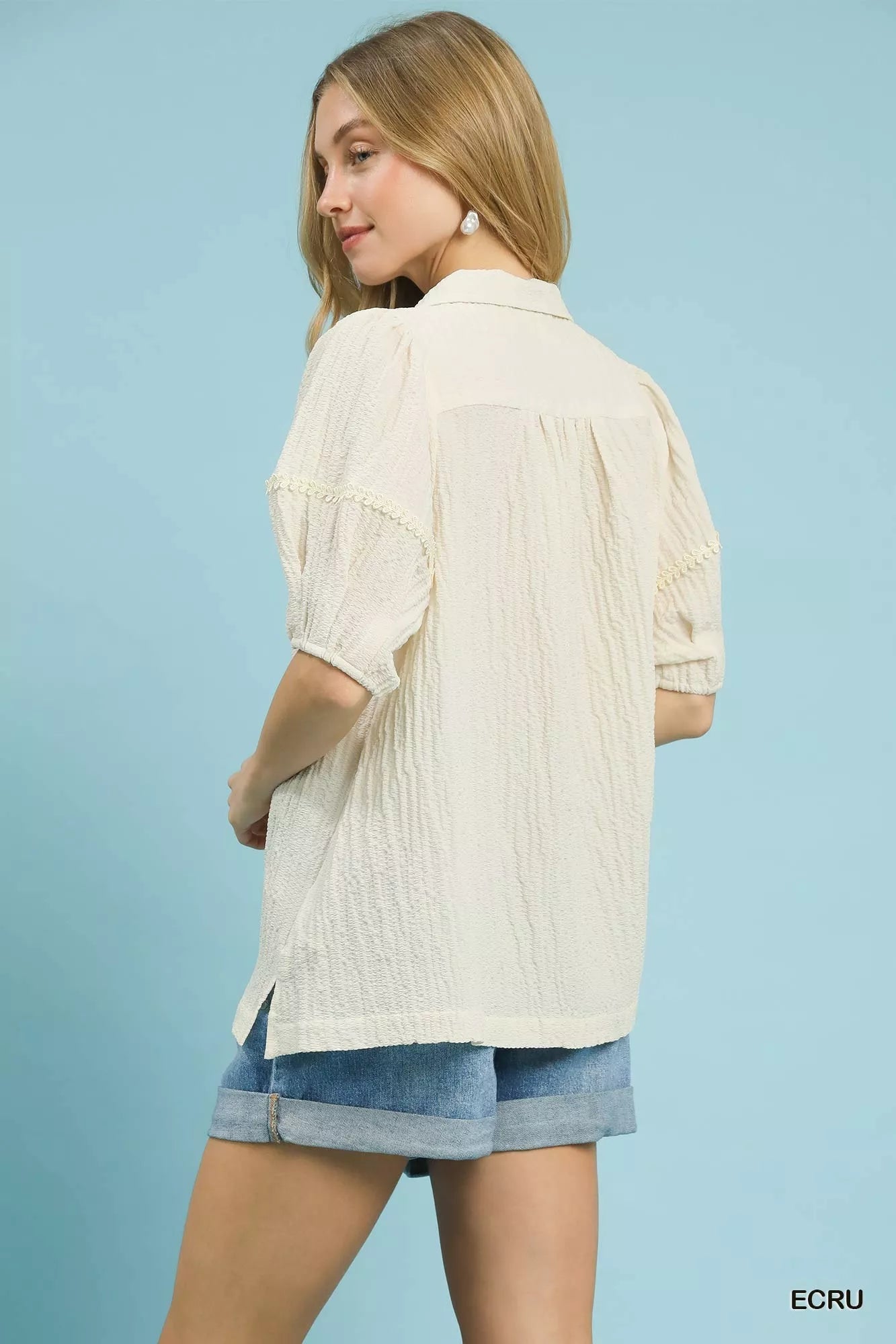 Ecru textured blouse with elbow-length sleeves and back yoke pleats