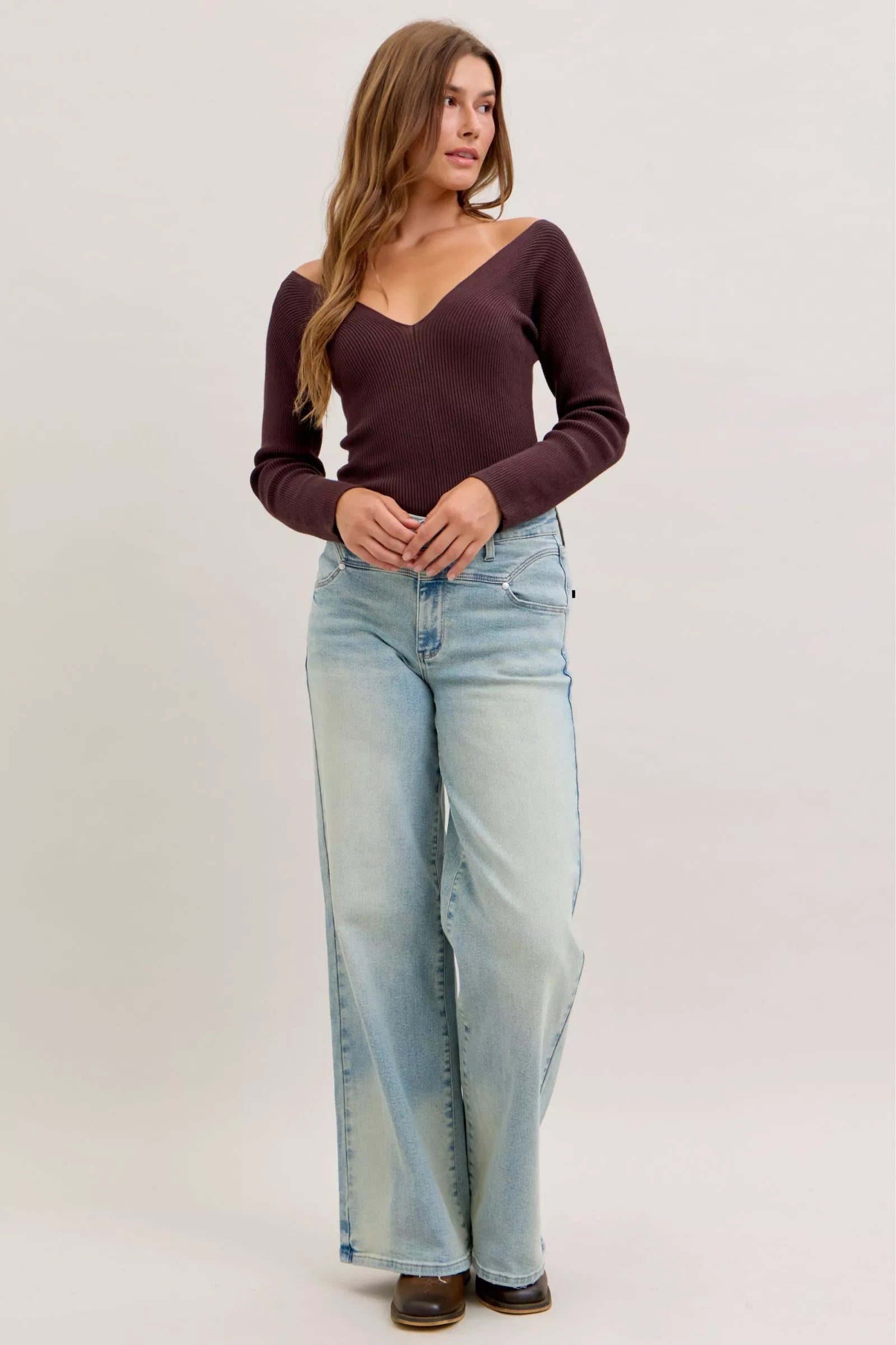 Light blue high-waist straight jeans with front pockets, belt loops, and zip fly