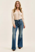 High-waist flare jeans in blue denim wash, wide bootcut silhouette with belt loops