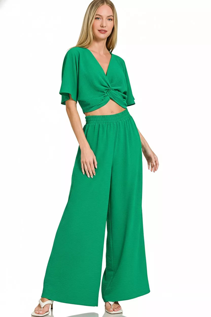Women's green cropped wrap-style top with twist and wide-leg pants, elastic waistband