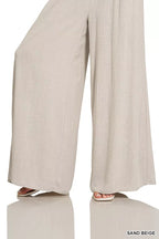 Sand beige wide-leg lounge pants with smocked waistband, full length