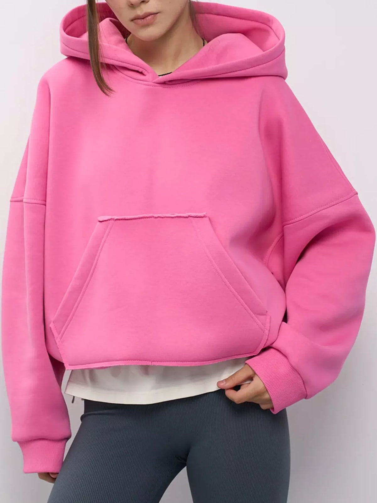 Pink oversized kangaroo pocket hoodie with front hood pocket and long sleeves