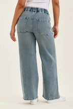 Medium-wash baggy jeans with back patch pockets and wide leg opening