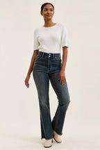 High-waist straight dark blue jeans with frayed hem and button-fly closure