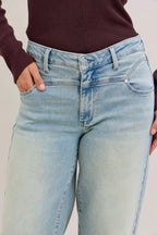 Light blue high-waist straight jeans with front pockets and belt loops, button fly.