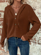 Brown waffle-knit button hoodie on model with hooded neckline and button front