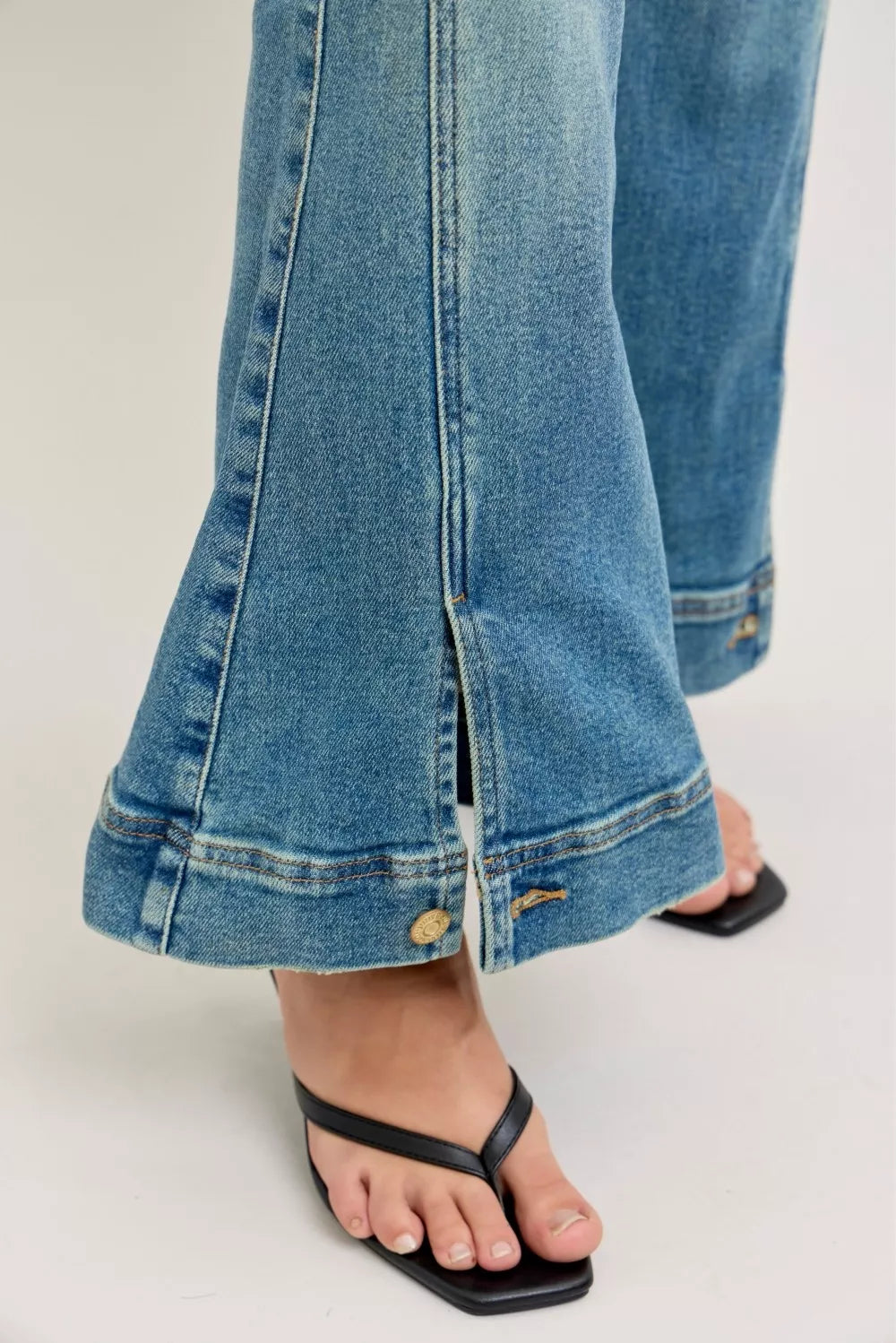 Flared denim jean leg with contrast stitching and ankle hem seam detail