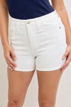 White denim shorts close-up: button fly, stitched seams, front pocket.
