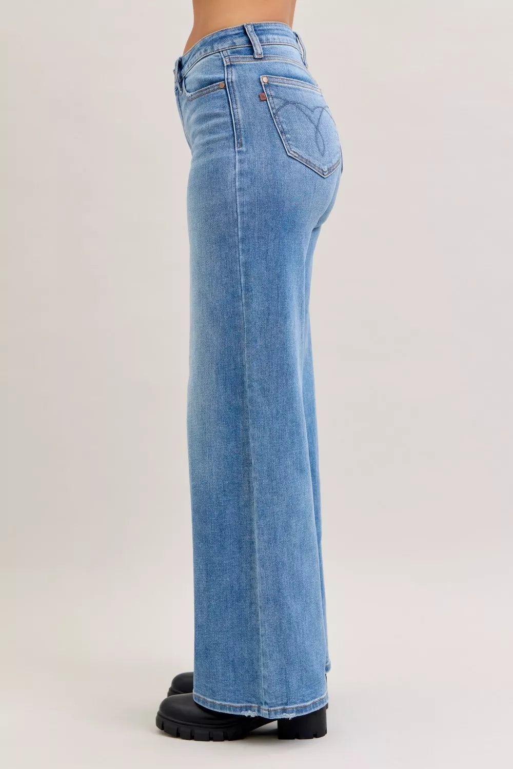 Light blue mid-rise wide-leg jeans rear view with stitched pockets and yoke