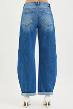 Dark wash mid-rise barrel jeans with back pockets and double roll cuffs