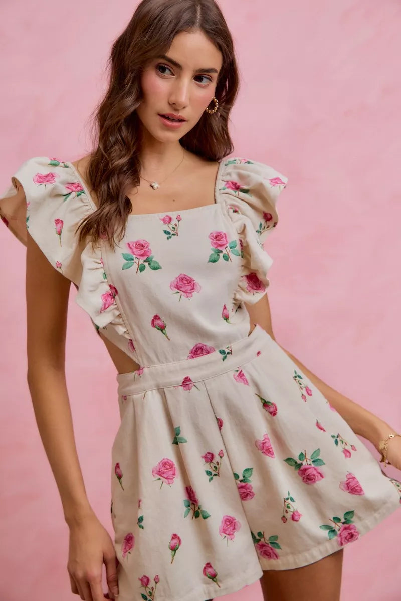 Ivory floral print denim romper with ruffled cap sleeves and pleated skirt