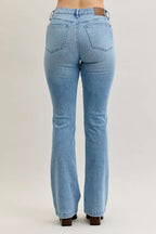 Light blue mid-rise bootcut jeans with rear patch pockets and back rise shaping