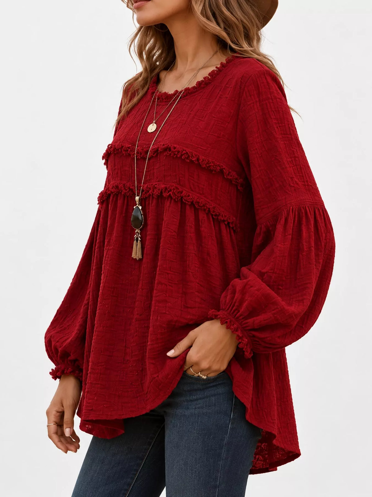 Red peplum blouse side view with frayed ruffle bands and elastic cuffed sleeves