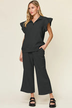 Black ruffle-sleeve top and wide-leg pants set with coordinated relaxed fit