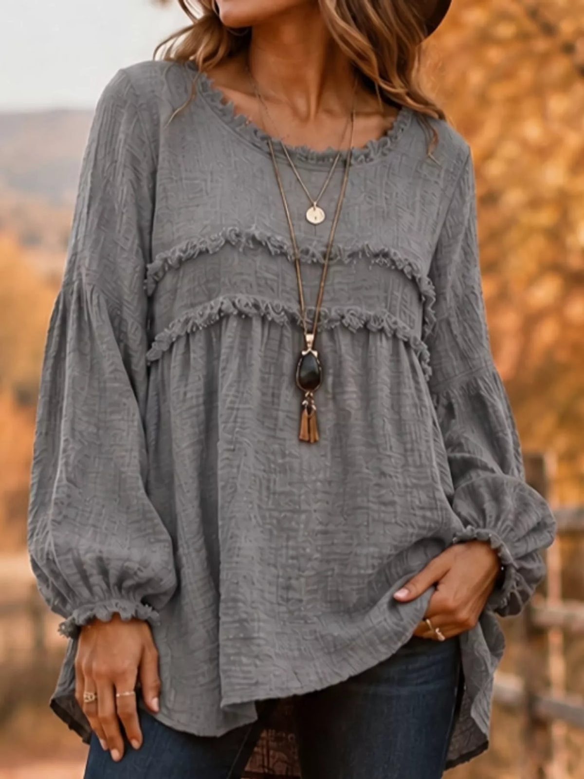 Gray frayed-trim peplum blouse with tiered ruffle yoke and long puff sleeves
