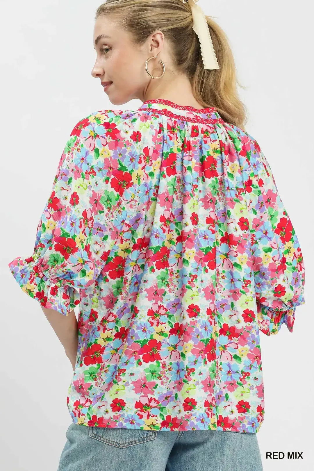 Red-and-blue mixed floral ruffle top, back view with three-quarter ruffle sleeves