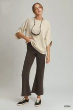 Ecru raglan sleeve round-hem top with crew neck and draped, relaxed sleeves