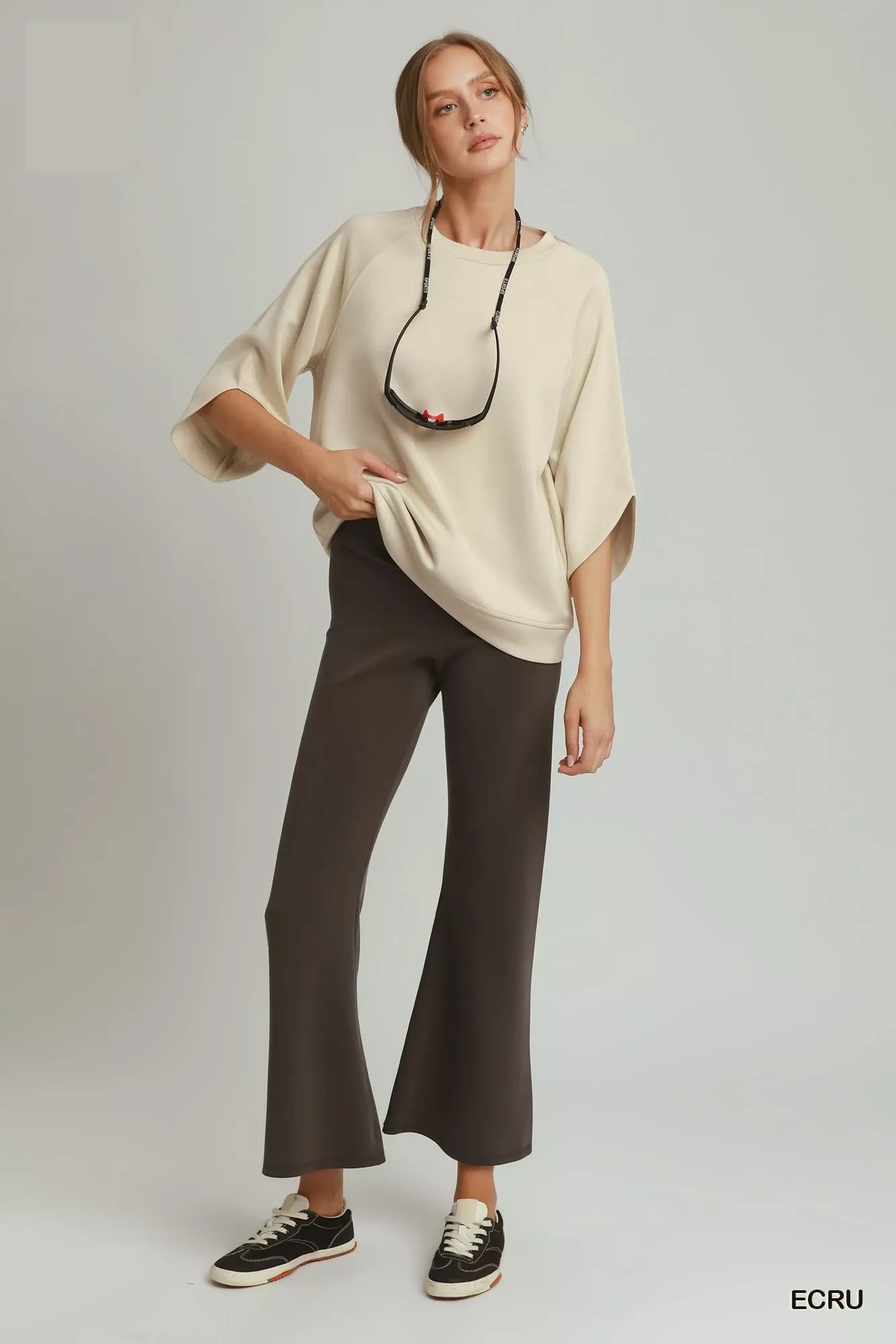 Ecru raglan sleeve round-hem top with crew neck and draped, relaxed sleeves