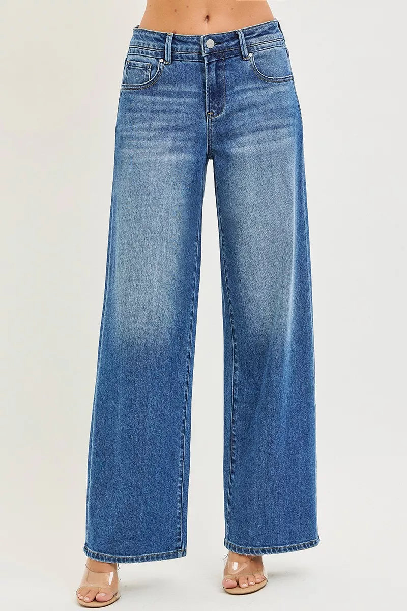 Women's medium-wash denim jeans, slouchy baggy relaxed fit, front button, pockets
