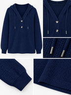 Navy waffle-knit button hoodie close-up with hood drawstrings and snap buttons