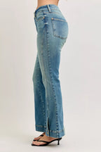 Back view of high-waist flare denim jeans in medium wash with belt loops