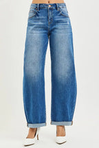 Dark wash mid-rise barrel jeans with button front and double roll cuffs