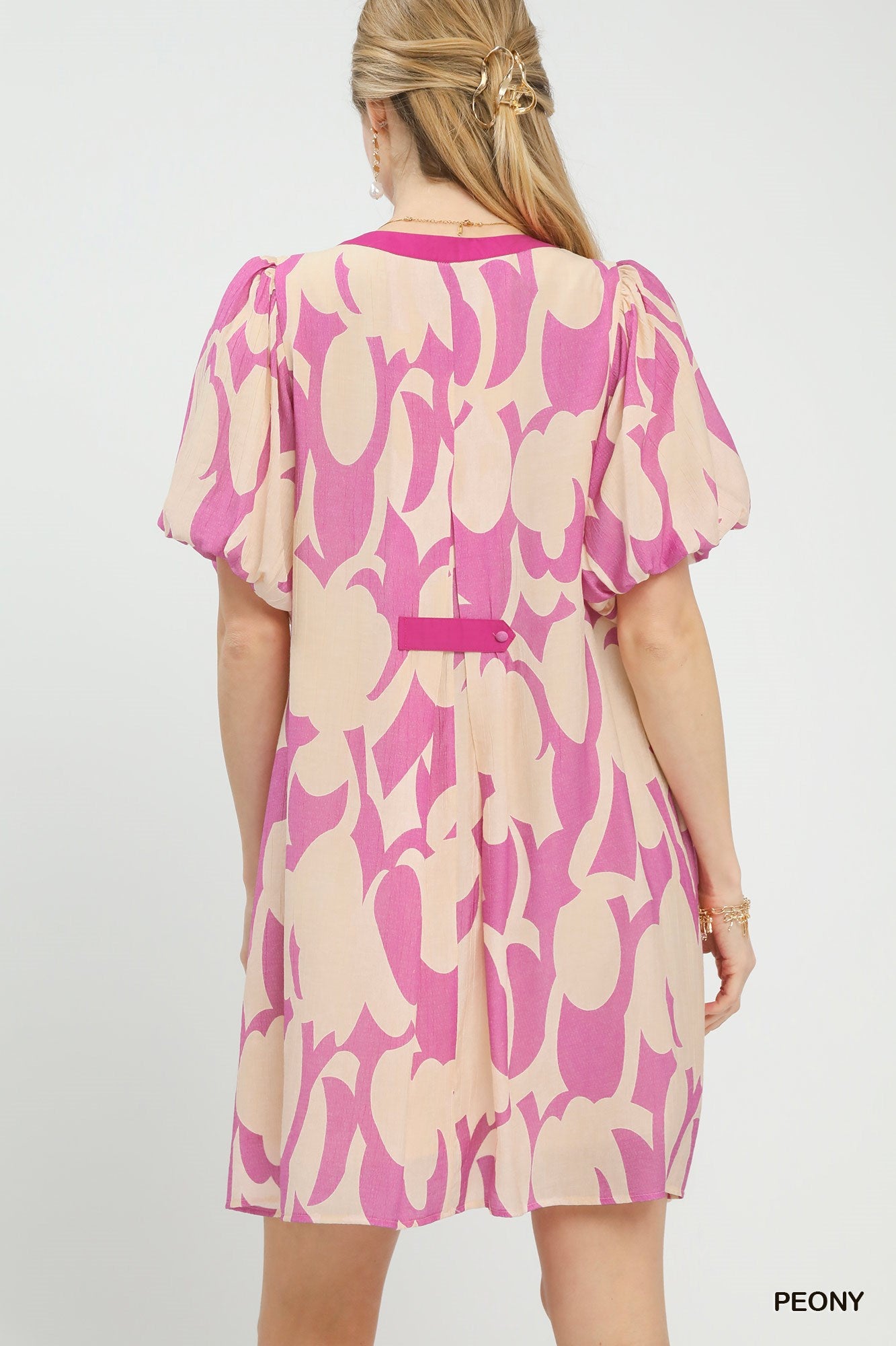 Pink and cream patterned mini dress back view with short puff sleeves