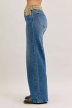 Women’s mid-rise straight jeans in blue denim with tan corduroy waistband, back view