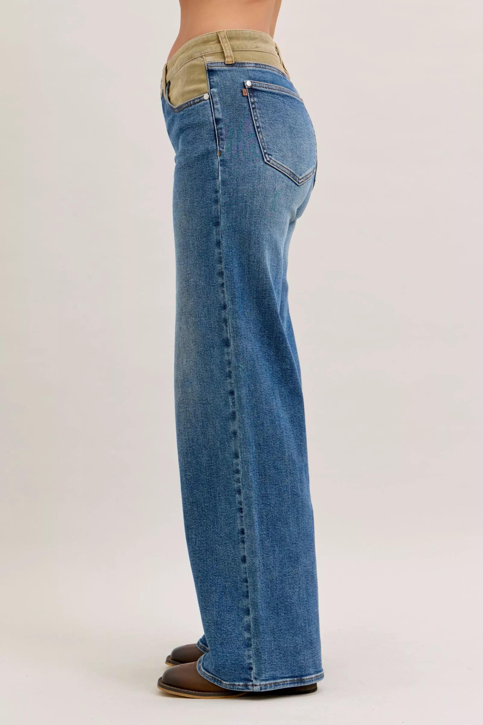 Women’s mid-rise straight jeans in blue denim with tan corduroy waistband, back view