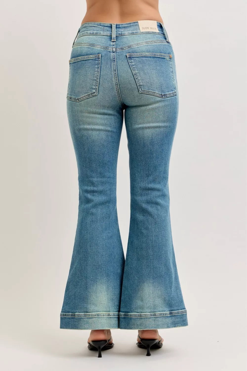 High-waist flare jeans with vintage wash, back pockets, and flared hem