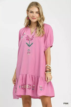 Pink babydoll dress with floral embroidery, puff sleeves, and tiered ruffle hem