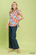 Floral blouse with smocked yoke and ruffle sleeves, blue base with colorful floral print