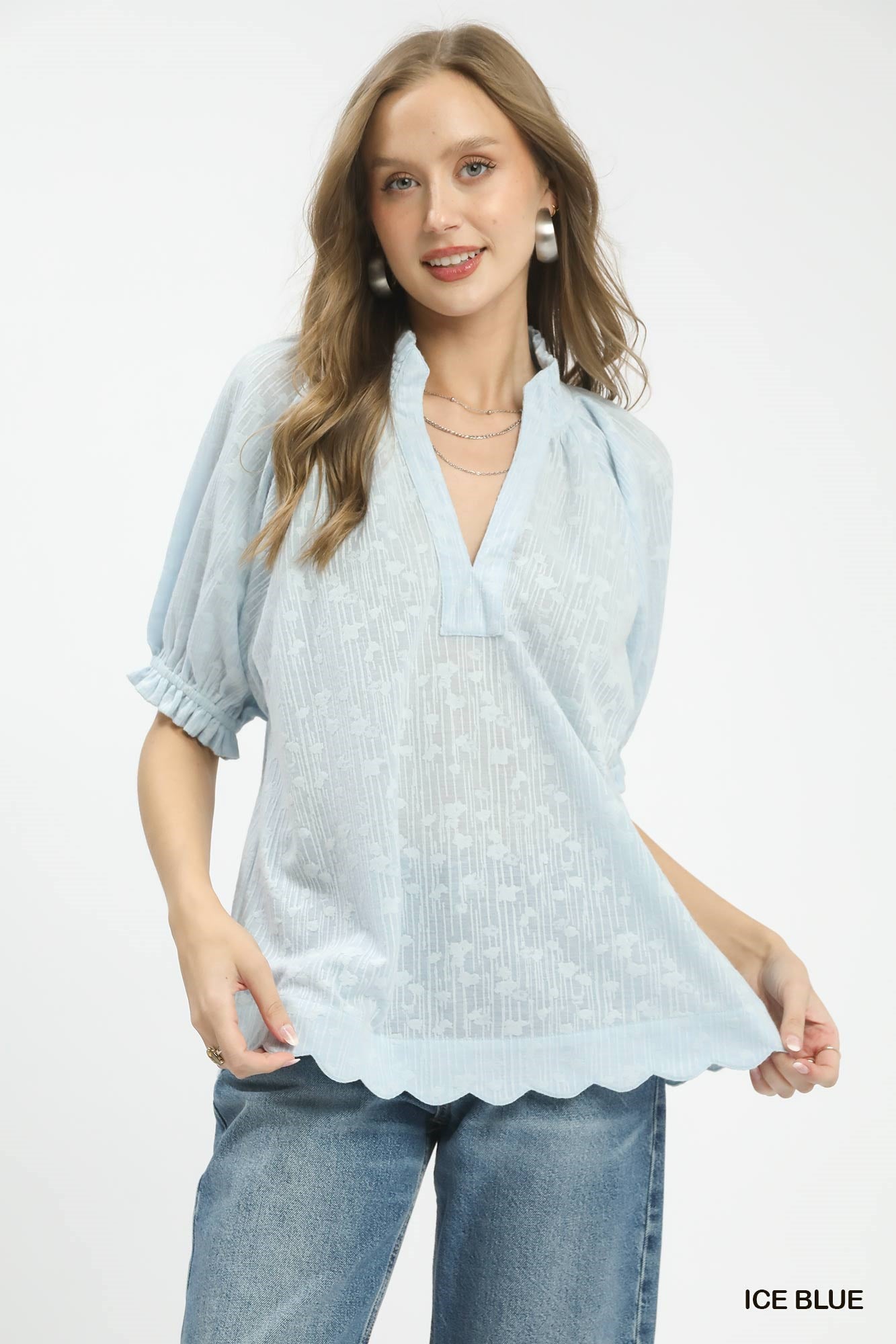 Ice blue pintuck ruffle blouse with V-neck and puff sleeves, scalloped hem