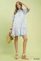 Light blue floral-print tiered mini dress on model, short ruffle sleeves and striped trim